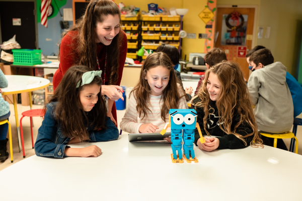 Three girls learning programming through Marty the Robot