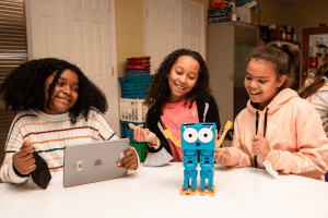 Three students learning with Marty the robot