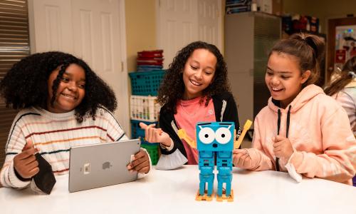 Marty in Grange Elementary Three students learning with Marty the robot