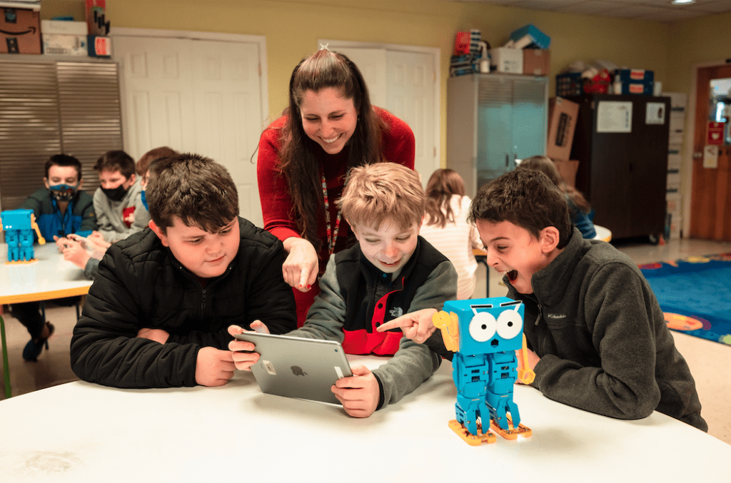 Students in Class with Marty the Robot A teacher with three students and Marty the Robot