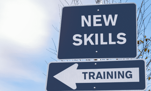 New Skills Navy blue road sign with white text of "new skills & training in this direction"